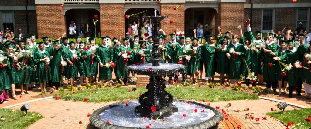 graduates throwing roses into air